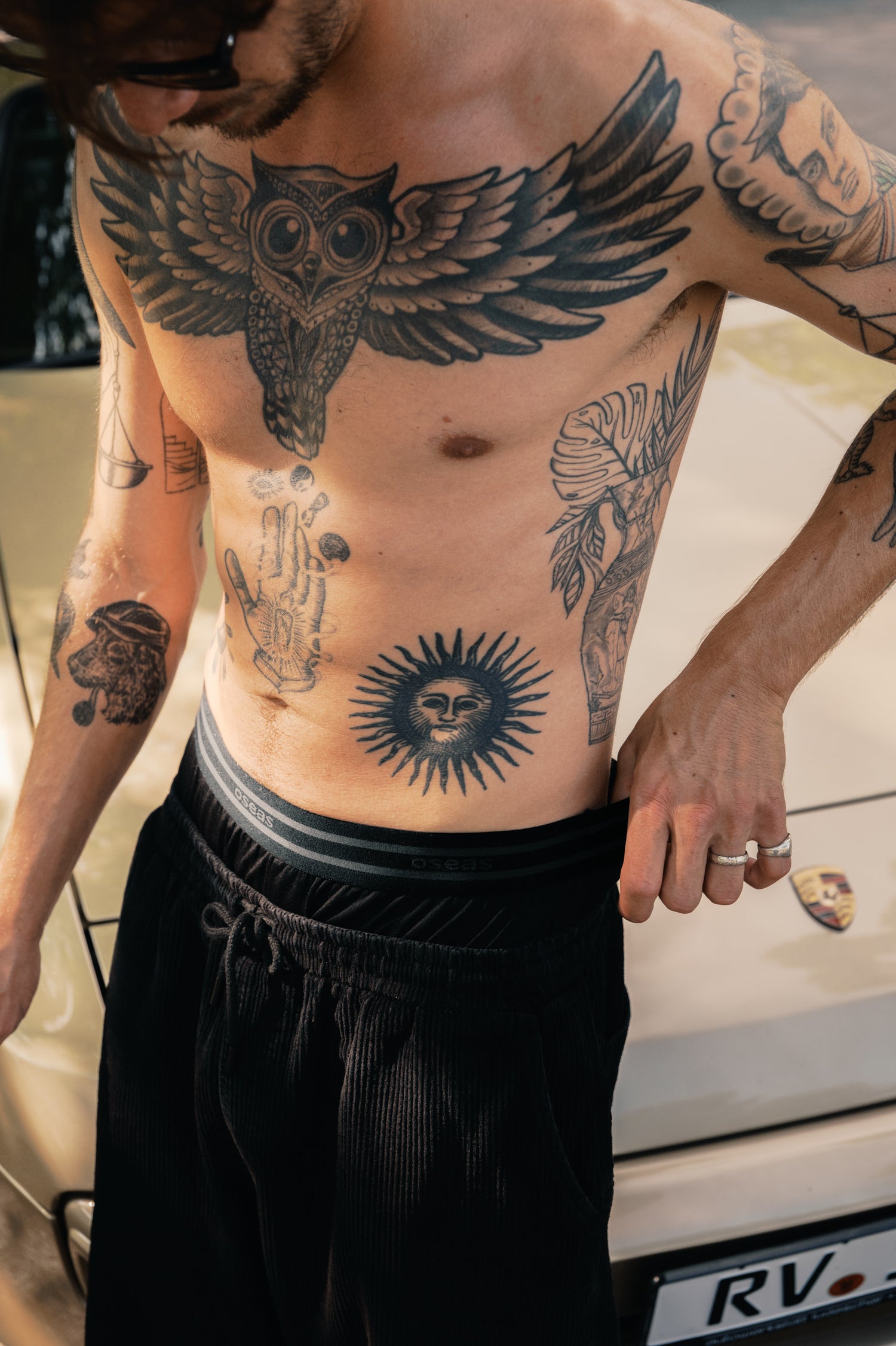 Mann trägt schwarze Boxershorts aus TENCEL™ Lyocell in weiter Passform vor Porsche.