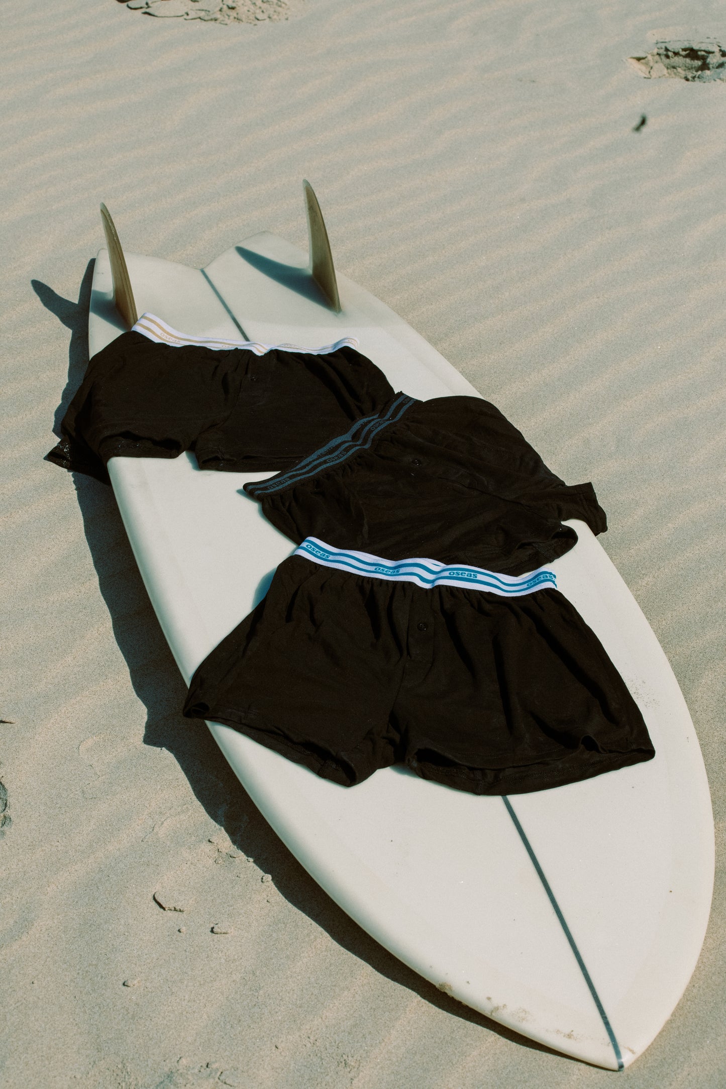 3er Pack oseas Boxershorts in unterschiedlichen Farbe auf einem Surfbrettn